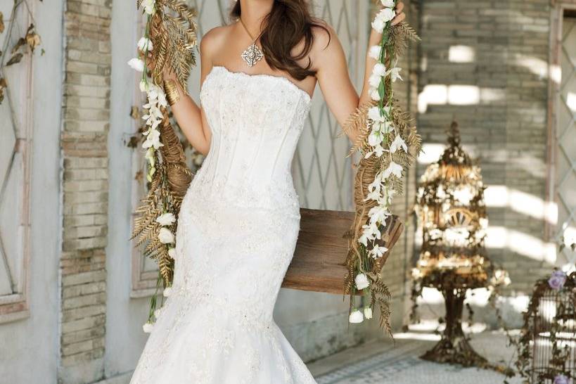 Style No. 41790_9342W <br>Turn your fairytale wedding dreams into reality when slipping into this breathtakingly romantic wedding dress comprised of all the necessary elements of a perfect bridal look. Heavenly design features of this strapless lace dress include a simple, square neckline with a front corset bodice that follows down to a trumpet-style bottom and lovely scalloped edges.