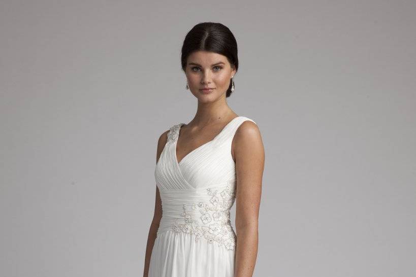 Style No. 41790_9345W <br>Emanate bridal goddess status in this everlastingly divine crinkle chiffon wedding gown beauty. Perusing this dress from head to toe, you'll notice that every design feature was artfully crafted to style perfection. Features that make this beauty extra special include a ruched, wide v-neck bodice that comes adorned with a flower side detailing comprised of breathtaking pearls and beads.