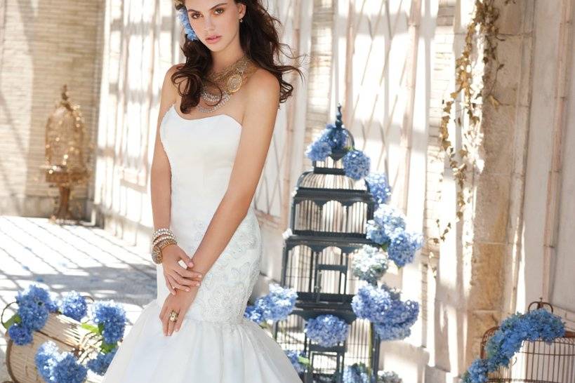 Style No. 41790-9350W <br>Incredible features of this strapless wedding dress include a scoop neckline and trumpet skirt that flares out to highlight its mermaid dress look. And if that wasn't beautiful enough, this style is also decorated with organza ribbon flowers.