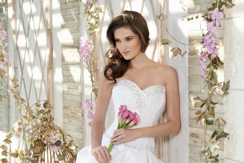 Style No. 42420_6195W <br>It's a fresh and vibrant look if you're opting for a different take on the traditional ball gown wedding silhouette. Fall in love with its features, which entail a short strapless taffeta corset that's bejeweled in beauty and follows down to a luxuriously designed bubble skirt, which creates a ravishing, voluminous composition.