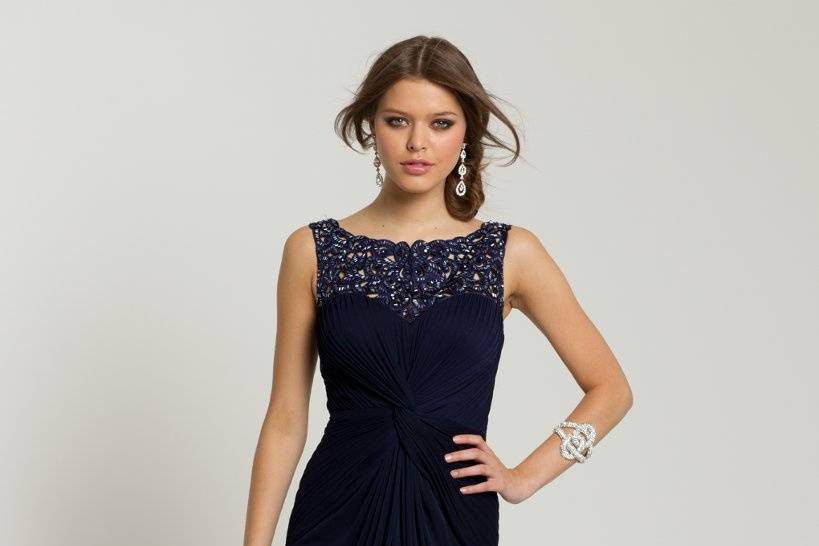 Style No. 28440_55893 <br>ordered with glitter and floral appliqued tulle, this prom dress is a feminine treasure that you will instantly fall in love with. The beaded empire waist is a sweet touch that enhances your figure and allows the full skirt too create a long leg-line for a beauteous stature.