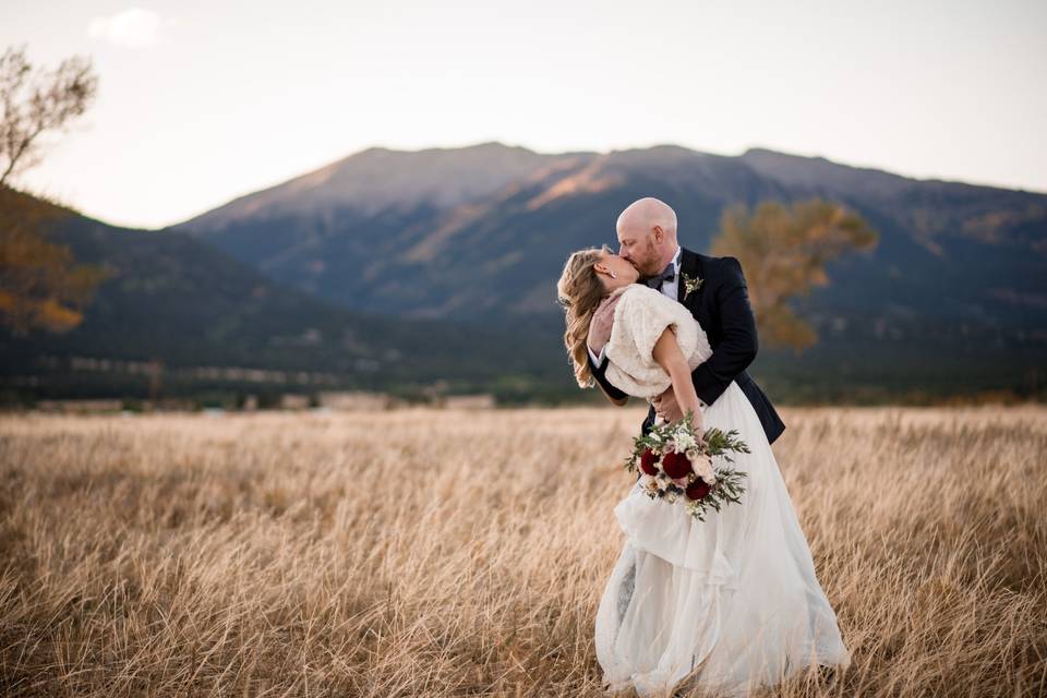 Bride and groom in field