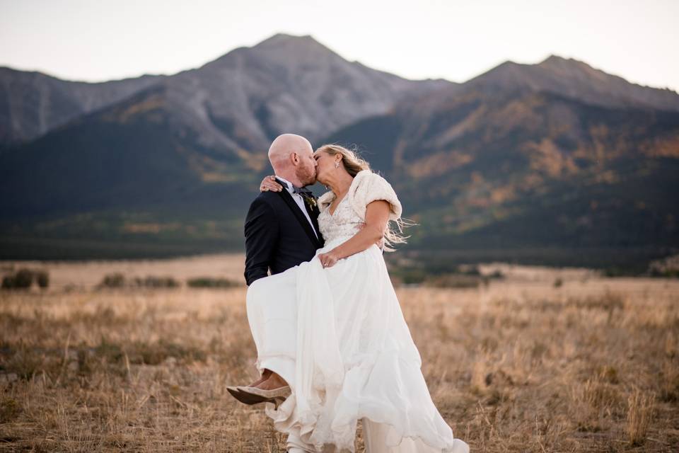 Bride and groom in field