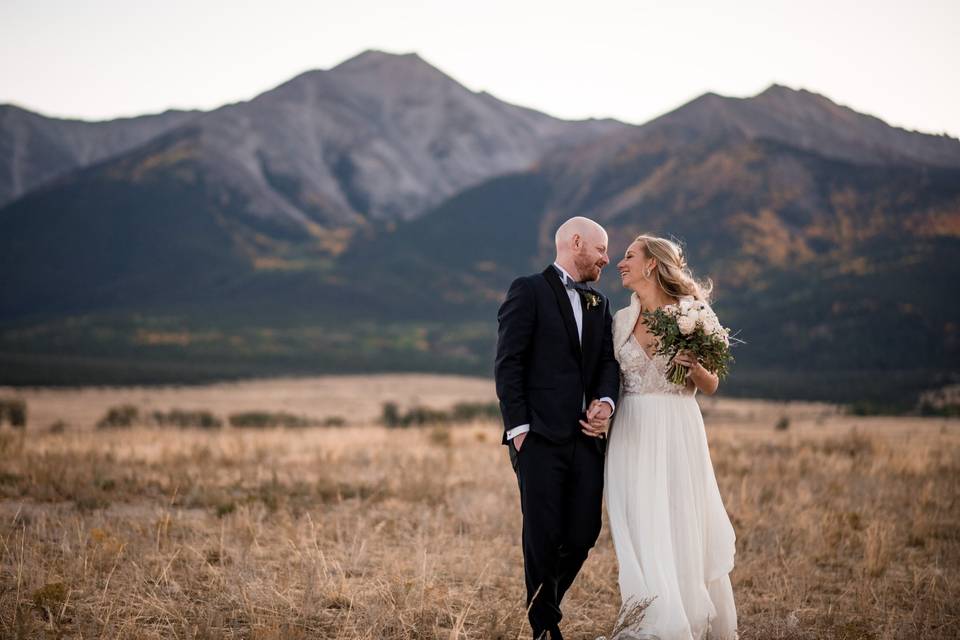 Bride and groom in field