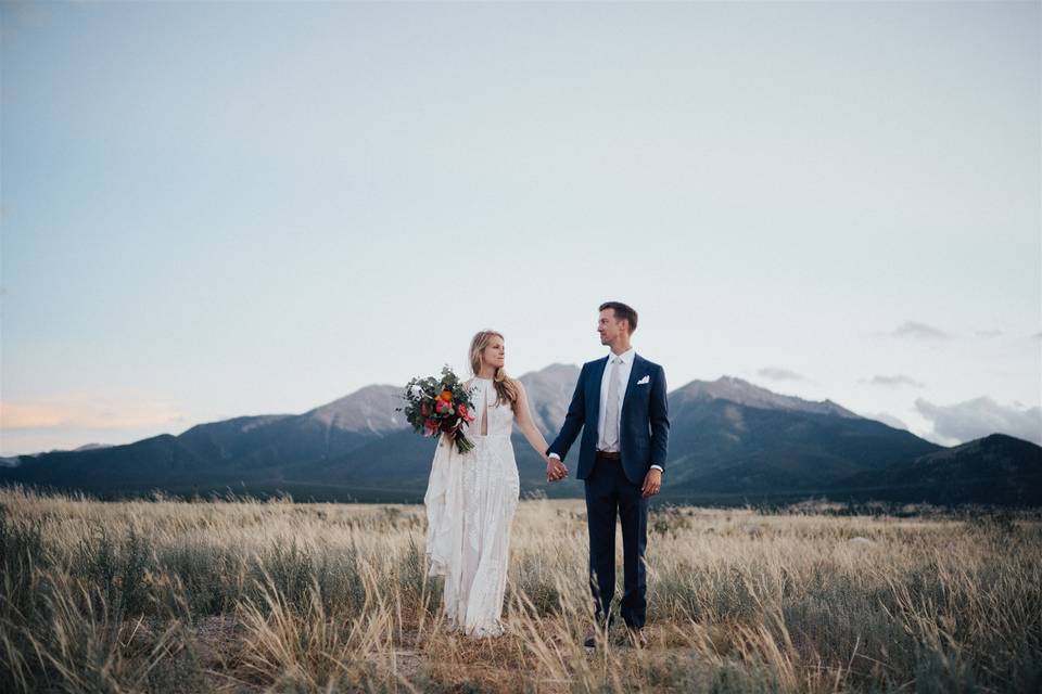 Bride and groom in field