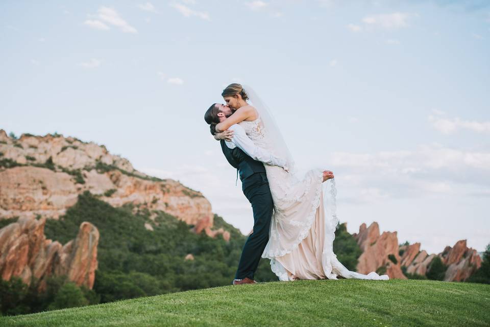 Groom picking up his bride