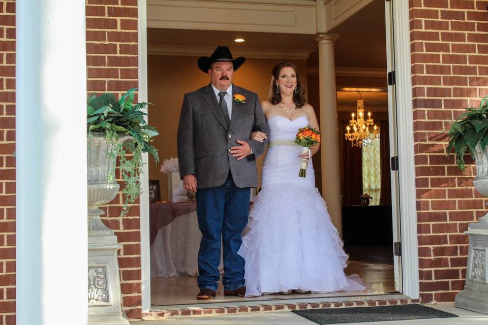 Walking through doorway in wedding attire