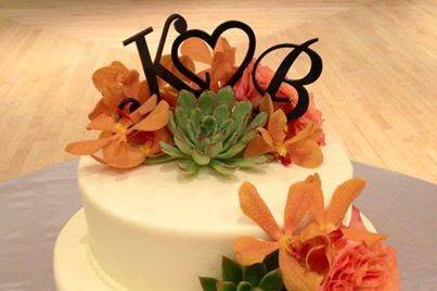 White wedding cake with orange flowers