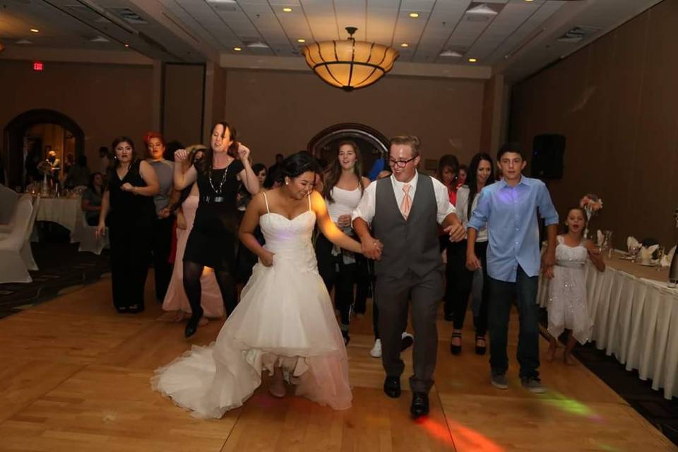 Couple and wedding party dancing