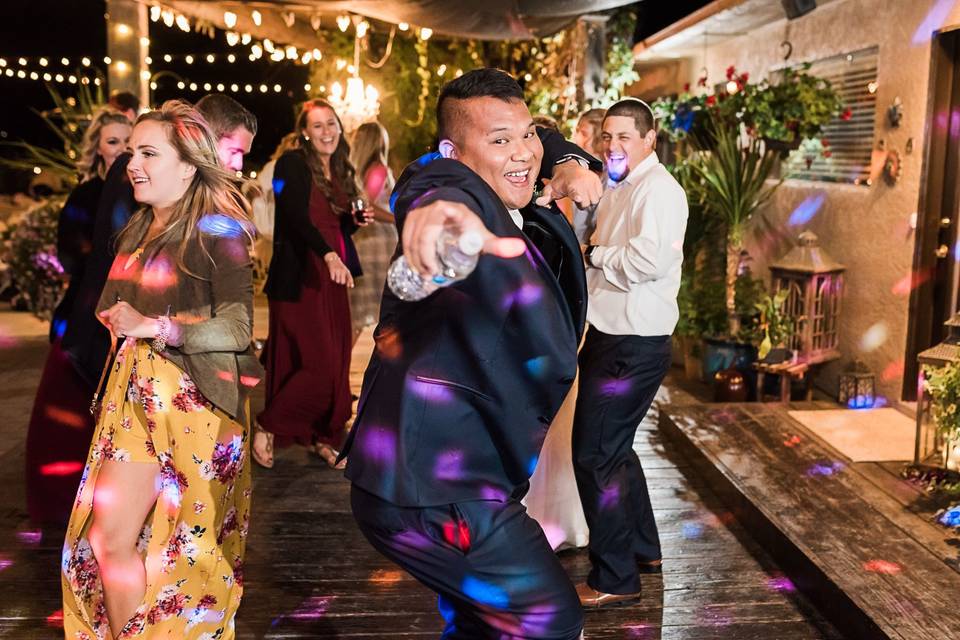 Couple and wedding party dancing