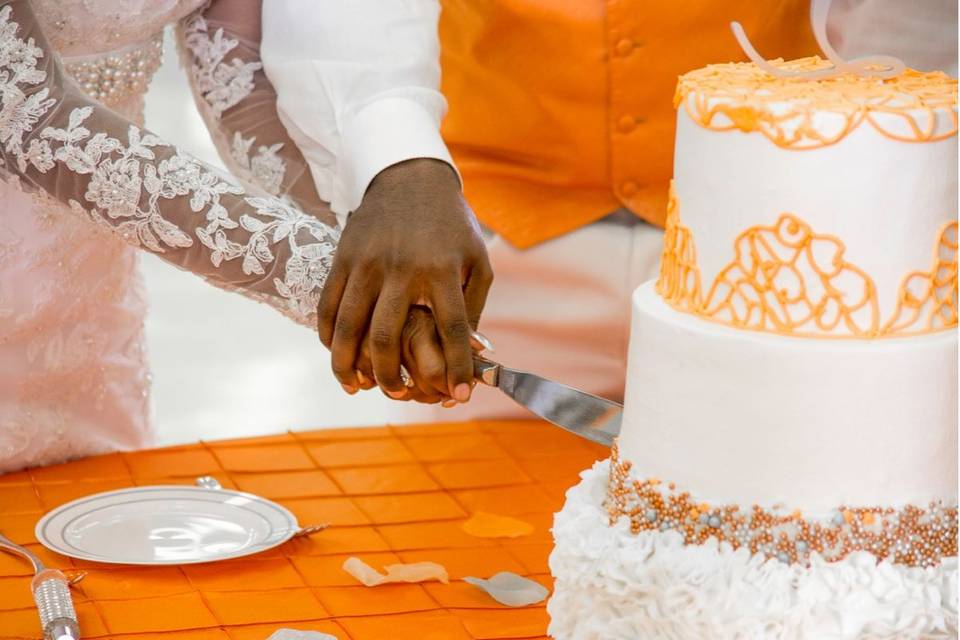 Couple slicing their wedding cake