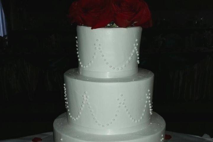 Wedding cake with red rosettes