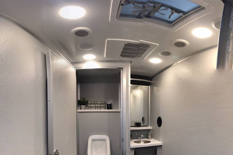 Men's room , quartz top, stainless sink, elegant soap & towel dispenser, urinal, mirror heat/AC, music