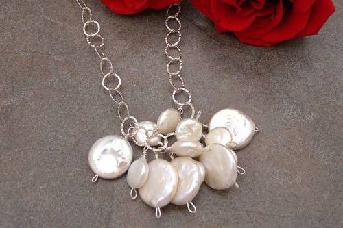 a profusion of multi sized coin pearls on a sterling silver chain.