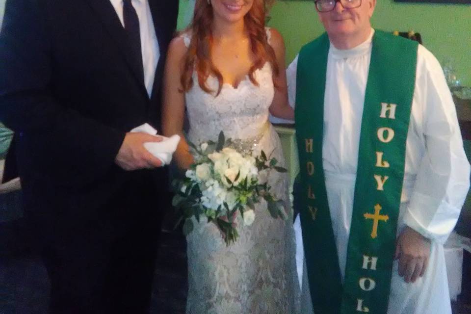 Bride and groom with Fr. Noel
