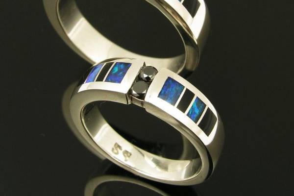 His and hers black diamond wedding set with Australian opal and black onyx inlay.  This wedding set is also available in his and his and hers and hers set combinations.