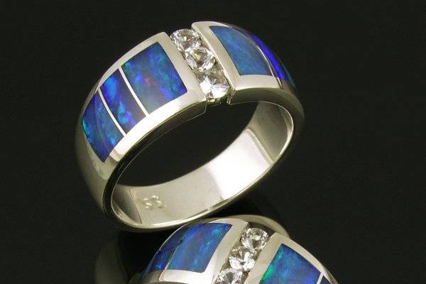 His and hers Australian opal and white sapphire wedding ring set in sterling silver.  This wedding set is also available in his and his or hers and hers set combinations.  The deep blue opal in this set is almost gone but we have lots of other color choices.