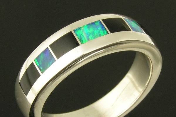 Sterling silver ring band inlaid with Australian opal and black onyx by Mark Hileman. The 3 pieces of inlaid Australian opal are a nice dark blue-green color. This handmade silver inlay ring would make a nice wedding band for someone not interested in the traditional gold band. The band is 6mm wide and is a size 10. I can re-make it in any special order size in less than 2 weeks. A matching his and hers wedding set could also be made by special order.