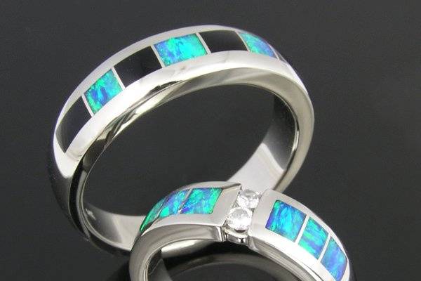 His and hers  sterling silver opal inlay wedding set.  Her ring features Australian opal inlay accented by white sapphires.  His ring is Australian opal and black onyx inlay.