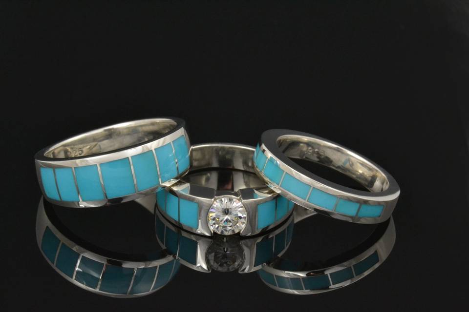 Turquoise wedding ring set featuring a brilliant round moissanite in the engagement ring.  All the rings are in sterling silver inlaid with matching blue turquoise.  This set is also available with other center stones and inlay materials by special order.  This set will be made to order in your ring sizes in 3 to 6 weeks.