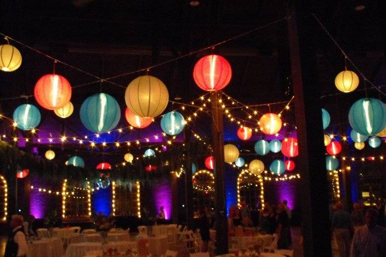 Lanterns, uplighting, and cake spot lighting make for a beautiful reception at the Roundhouse Depot