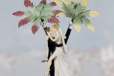 This beautiful Hawaiian themed cake topper features real sand and shells with two adorable palm trees with coconuts. The funny, sexy bride and groom will be sure to make a statement at your wedding shower or reception. Skirt is made of organza.
SKU: 101305
$56.95
http://www.weddingcollectibles.com/HawaiianBeachWhiteCakeTopper.html