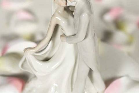 This elegant fine porcelain couple is hand painted and features a glazed finish. A perfect addition for your guestbook table, or to crown the top of your wedding cake!
SKU: 707568
$24.95
http://www.weddingcollectibles.com/Elegant-Porcelain-Wedding-First-Kiss-Bride-and-Groom-p-624.html