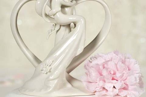 This elegant white porcelain heart with Groom holding Bride cake top figurine is the perfect item to top your cake! This item can also be used as the finishing touch to decorate your sign in guest book table! Set the tone of your wedding the minute the guests arrive. Perfect for a heart themed wedding!
SKU: 707518
$29.95
http://www.weddingcollectibles.com/Heart-with-Groom-Holding-Bride-p-156.html