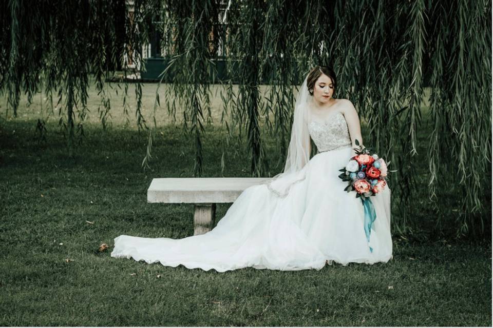 A bride under on a garden bench