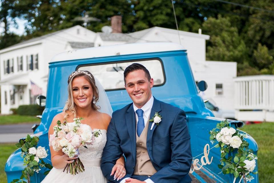 Vintage blue truck and fresh white roses