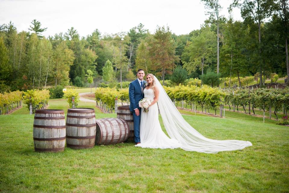 Posing next to authentic wine barrels