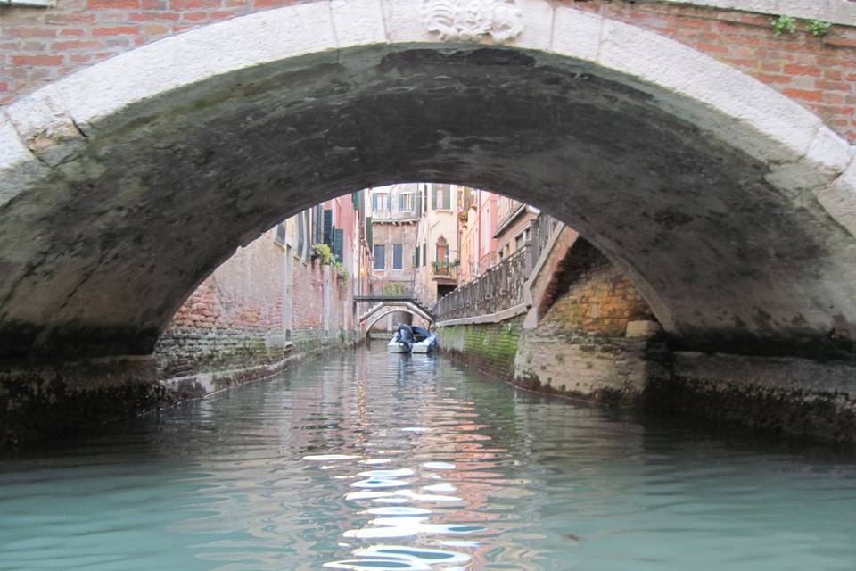 Going down the canals in Venice