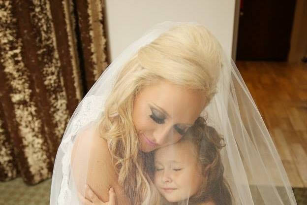 Bride hugging the flower girl