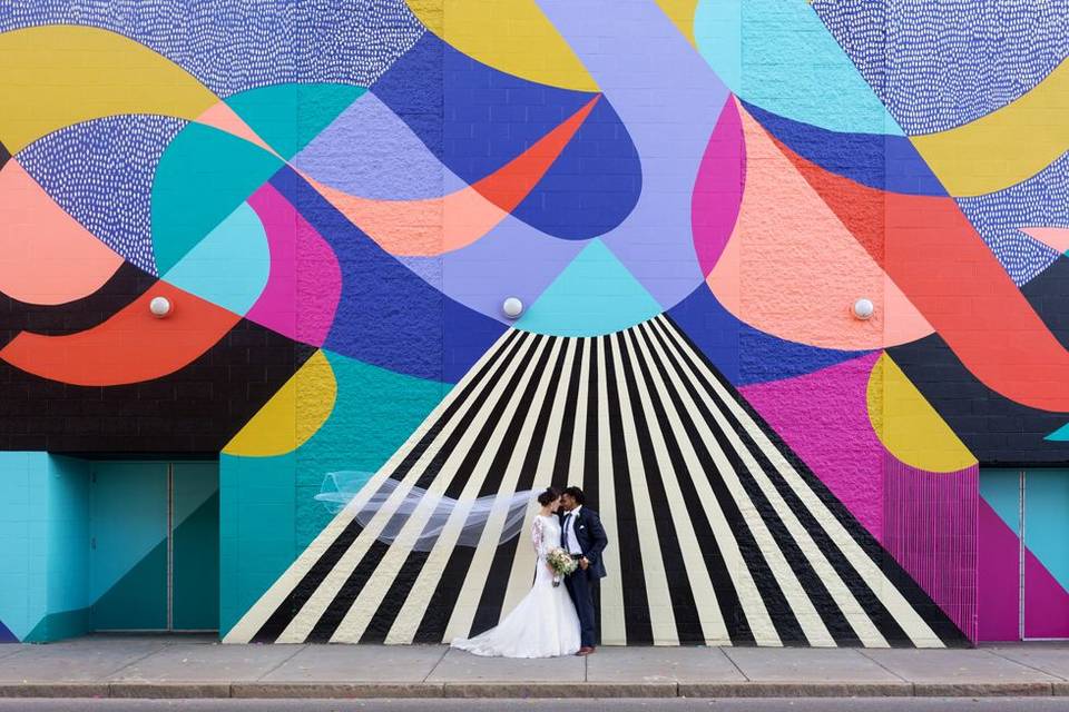 Wedding couple Standing in from of mural in Buffalo New York, Photo taken by Lovely Day Photo