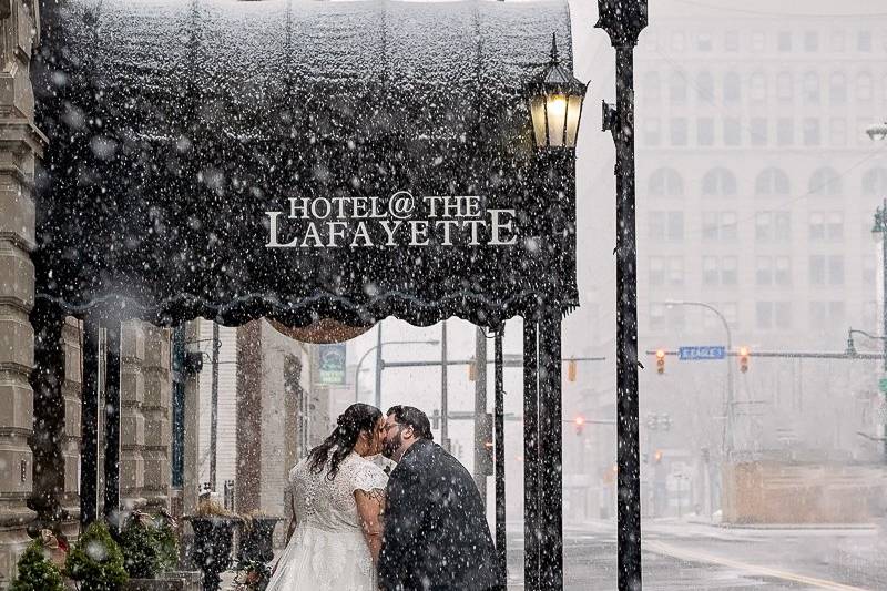 Bride and groom kiss in snow