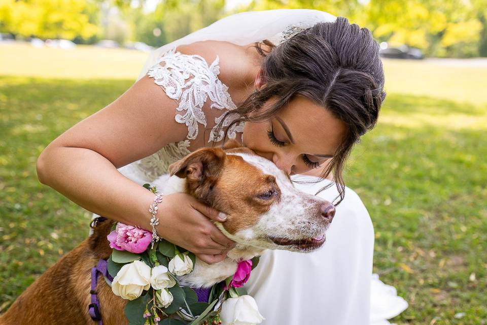 Bride kissing dog