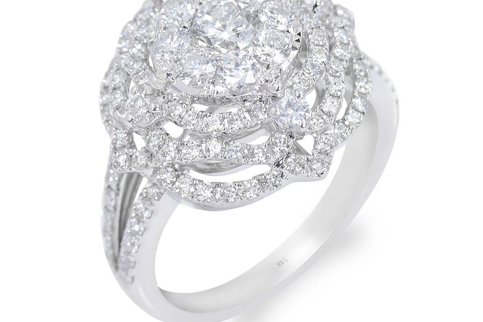 Bloom MagnifiqueExquisite diamond ring boasts of a round center diamond with multiple bands of accent diamonds surrounding it. Its split shank is lined with pave diamonds. Diamond : 1.80 Carats ApproxCut: Round BrilliantColor: E-FClarity: VS-SIGold Karat: 14kt.Gold Color: White GoldGold Weight : 5.3gSize: 7 (54.4 MM)