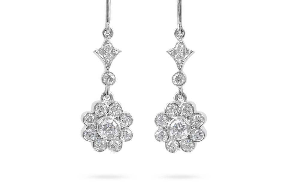 Floral CharmsA dainty layer of round diamonds leads to a feminine display of diamonds dangling in a floral shape. Diamond : 0.46 Carats Approx.Cut : Round BrilliantsColor : E-FClarity : VS - SIGold Karat : 14kt.Gold Color : White GoldGold Weight : 3.45g