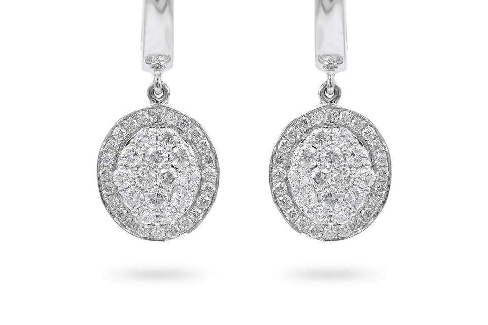 OvostarsWhite gold drop earrings exhibit an oval diamond center with accent diamonds surrounding it. Diamond : 0.60 Carats Approx.Cut : Round BrilliantsColor : E-FClarity : VSGold Karat : 14kt.Gold Color : White GoldGold Weight : 4.4g