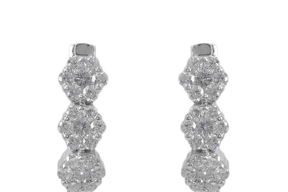 TrifloraThree vivid clusters of diamonds aligned together beautifully to create a stunning pair of drop earrings. Diamond : 0.57 Carats Approx.Cut : Round BrilliantsColor : E-FClarity : SIGold Karat : 14kt.Gold Color : White GoldGold Weight : 2.6g