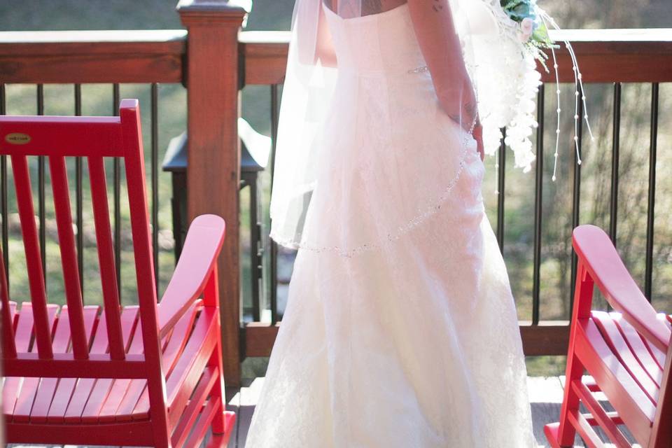 On the deck with red chairs