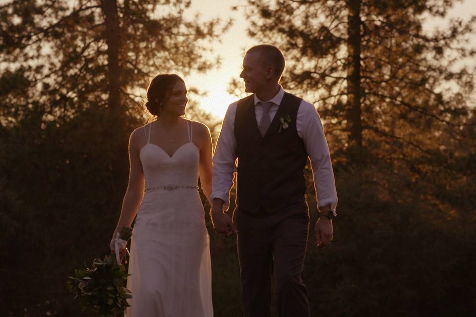 Newlyweds holding hands sunset