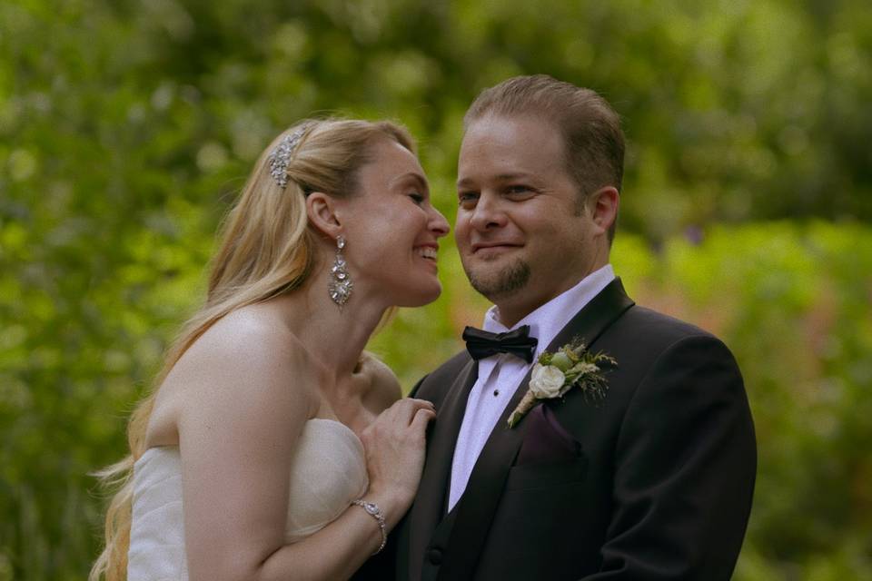 Bride + groom sharing a secret