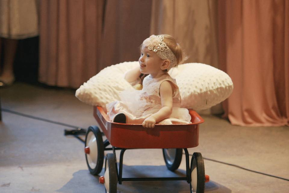 Flower girl in a red wagon