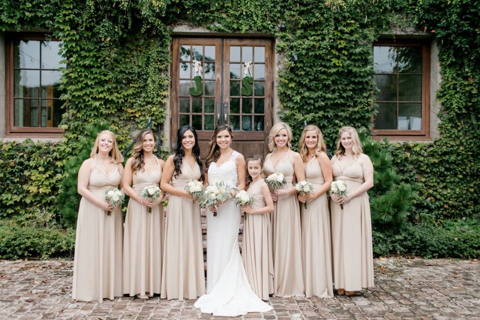 Wedding dress hanging by brick wall