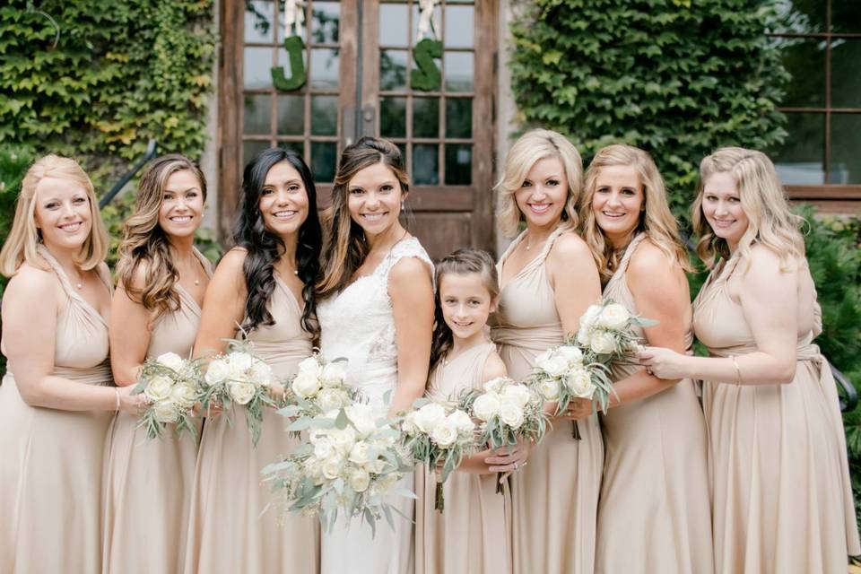 Wedding party standing in front of vines