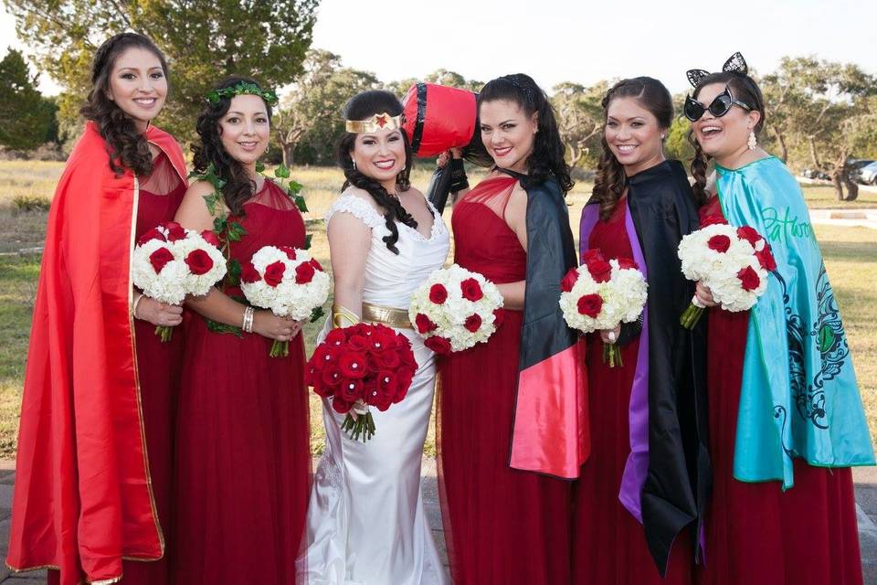 Bridesmaids and their capes beside the bride