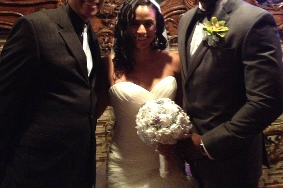 Beautiful bride and groom during the ceremony at the altar. Also visible is the best man, the groom's brother.A spectacular day