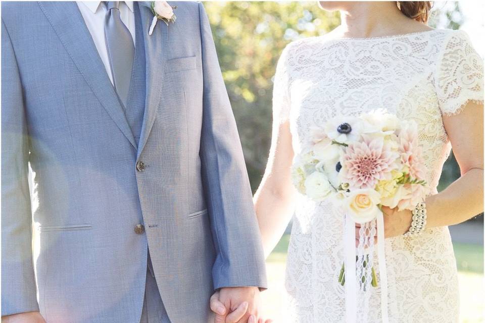 Couple showing off their elegant wedding attire