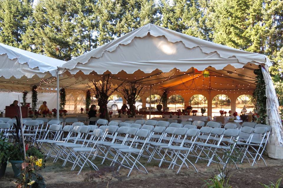 Your outdoor wedding doesn't have to be one big tent. Multiple tents can be placed to work around landscape features and pools. Seating was in place for the ceremony and then moved under tent for dinner.